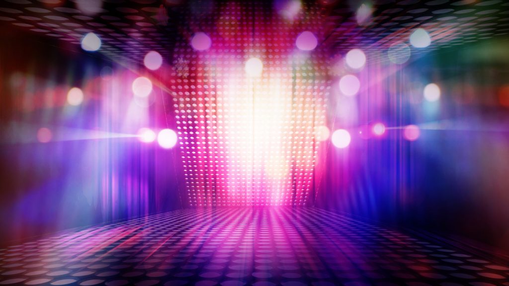 blurred empty theater stage with fun colourful spotlights, abstract image of concert lighting illumination background